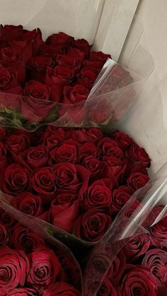 two large bouquets of red roses are in the middle of each other's petals