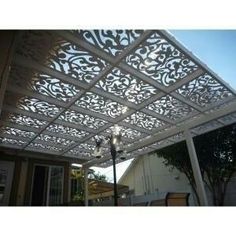 a white pergolated roof with an intricate design on it