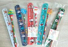 five christmas themed toothbrushes in plastic wrappers