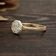 a diamond ring sitting on top of a wooden table