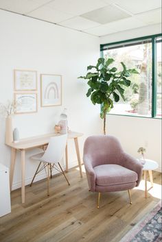 a living room with a chair, table and potted plant