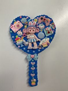 there is a blue and white key shaped like a girl with many things on it