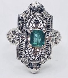 Vintage Art Deco filigree 14k gold and emerald ring Antique Emerald Ring With Prong Setting, Silver Emerald Ring In 14k White Gold, Platinum Emerald Ring In White Gold, Antique Emerald Cut Emerald Ring, Antique Style Emerald Cut Emerald Ring With Prong Setting, Antique White Gold Emerald Ring, Antique Hallmarked Emerald Ring In White Gold, Art Deco Green Emerald Ring With Diamond Cut, Classic Emerald Ring With Intricate Design