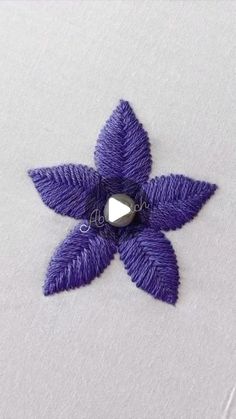 a purple flower with a diamond in the center