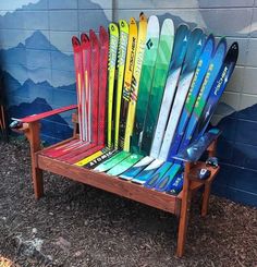 a chair made out of skis sitting in front of a wall