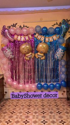 a baby shower decoration with balloons and streamers