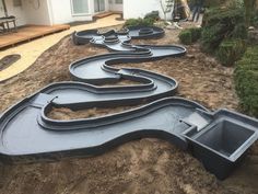 an outdoor play area in the middle of a yard that is being constructed with black plastic