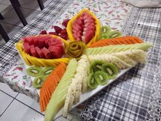 there are many different fruits on the plate and one is cut in half to look like leaves