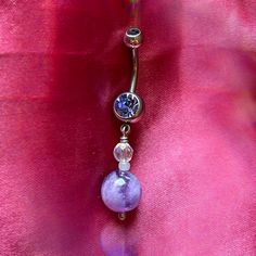 Strengthen your intuition with this amethyst dangle belly ring. Made with ethereal shades of lilac, deep purples, holographic clears and hints of creme. The vibe of this piece is reminiscent of a magical woodland <3 Amethyst also happens to be the birthstone of February! To prolong lifetime of piece, remove before showering/bathing/swimming and keep in a cool, dry environment! Handmade in Davis, CA! Mystical Internally Threaded Jewelry For Gifts, Mystical Internally Threaded Jewelry For Gift, Mystical Internally Threaded Jewelry As Gift, Purple Internally Threaded Jewelry As A Gift, Purple Internally Threaded Jewelry Gift, Hypoallergenic Purple Drop Jewelry, Purple Hypoallergenic Drop Jewelry, Summer Belly Rings, Shades Of Lilac