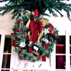 a christmas wreath hanging on the front door