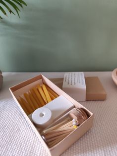 a box filled with matches and candles on top of a table