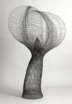 an artistic sculpture made out of wire on a white background