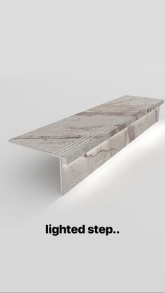 a white marble bench with the words lightened step on it's left side