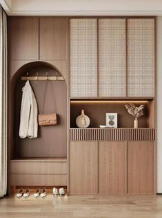 an entryway with wooden cabinets and white shoes