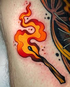 a close up of a person's chest with a tattoo on it that has flames coming out of them