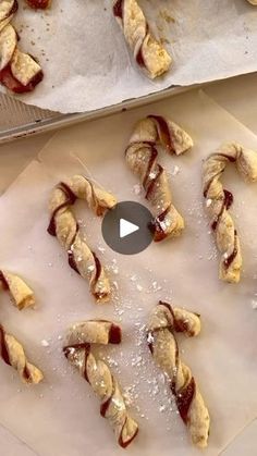 several pastries are being prepared on a sheet of wax paper and then placed on top of each other