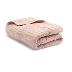 a pink blanket folded on top of a white background