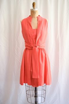 Mr Mort by Stan Herman | Vintage 60s Salmon Pink Dress Sleeveless Linen Sash Tie Summer Dress Deep Placket Neckline Sz MDETAILS: *1960's salmon pink linen*Sleeveless mini dress *Overlapping front placket neckline - includes snaps as dress closure*Wide sash belt tie with lovely fringe*Gathered skirt*2 side seam pockets*Fully linedLABEL: Mr. Mort by Stan HermanCONDITION: Color is vibrant and the dress looks like new! There is a small pin mark on inside of front placket. Small hole on back lower le Spring Sleeveless Dress With Sashes, Chic Sleeveless Dress With Sashes, Sleeveless Summer Dress With Sashes, Mod Sleeveless Workwear Dresses, Mod Sleeveless Lined Dress, Sleeveless Mod Dresses For Daywear, Pink Linen Dress, Fashion Newsletter, 1960's Dress