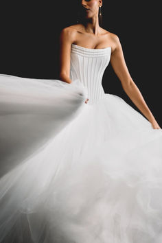 Float down the aisle in this dreamy strapless wedding dress. With a structured bodice and cascading tulle skirt, this gown is the epitome of romantic elegance. Perfect for a grand wedding look that feels timeless and regal.