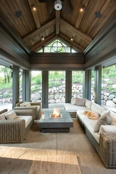 a living room filled with furniture and a fire place in the middle of an open floor plan