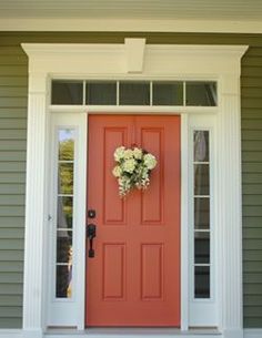 a red front door with white flowers on it