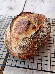 a loaf of bread sitting on top of a cooling rack