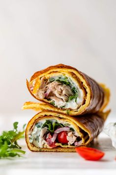 two wraps filled with meat, vegetables and cheese