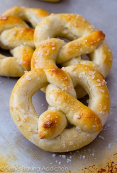 some pretzels are sitting on top of a baking sheet covered in sea salt