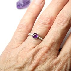 February's birthstone amethyst is such a popular color. This gorgeous deep dark orchid purple warms my heart. I decided to set this 6mm cabochon in a simple modern setting. A stackable silver ring with a trendy colored round gemstone dot in a circular bezel. Ring shank measures 1.9mm. **Made to order in your size (please allow 3-5 days) nangijalajewelry.etsy.com *Gemstone colors might vary slightly Modern Purple Jewelry For Gifts, Modern Purple Jewelry As A Gift, Classic Amethyst Birthstone Jewelry, Amethyst Ring With Natural Stones For Healing, Classic Amethyst Birthstone, Cabochon Amethyst Gemstones For Anniversary, Anniversary Cabochon Amethyst Gemstone, Amethyst Cabochon Gemstones For Anniversary, Anniversary Amethyst Cabochon Gemstone