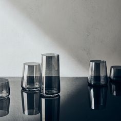 several glasses are lined up on a table