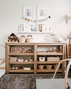 a living room filled with furniture and baskets on top of a wooden shelf next to a window