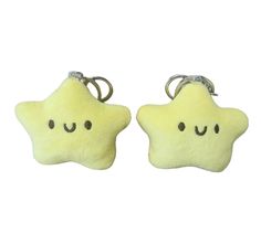 two star shaped key chains with faces drawn on them, one is yellow and the other has black eyes