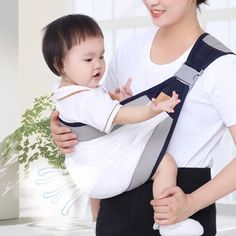 a woman holding a baby in a sling with an infant on it's back