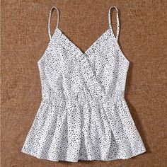 New, Never Worn, No Known Flaws. Very Versatile Top. Can Easily Be Dressed Up Or Down. Wear Layered, Underneath A Sweater Or Jacket, On Its Own Cinched Waist. Peplum Style. Adjustable Spaghetti Straps. Sleeveless Polka Dot Tops For Vacation, Casual Polka Dot Tank Top, Chic Polka Dot Tank Top For Summer, White V-neck Camisole With Ruffles, Ruffled V-neck Camisole For Vacation, White V-neck Ruffled Camisole, Chic Polka Dot Tank Top For Spring, Spring Chic Polka Dot Tank Top, Polka Dot V-neck Top With Ruffles