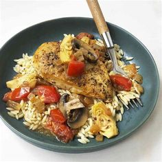 a blue plate topped with chicken, rice and veggies next to a fork