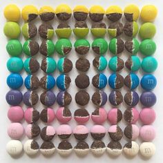 an art work made out of candy and chocolates with the letter m on it