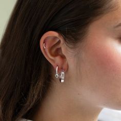 A tiny Aquamarine bezel set heart charm dangles from pavé huggie hoop earrings.| Lead and Nickel free.Sold as a PAIR .925 Sterling Silver Aquamarine Cubic Zirconia Gemstone Heart Charm 5mm(0.2in) Hoop: Inside Diameter 9mm(0.35in), Thickness 1.5mm(0.06in) Hinge closure #E445-SAQ Silver Elegant Huggie Earrings With Heart Charm, Silver Sterling Huggie Earrings With Heart Charm, Silver Huggie Earrings With Heart Charm, Heart-shaped Sterling Silver Huggie Earrings, Silver Huggie Clip-on Hoop Earrings, Knots Jewelry, Jewelry Gift Guide, Choker Pendant, Moms Bracelet