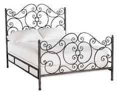 an iron bed frame with white sheets and pillows on top of it, against a white background