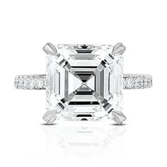 an emerald - cut diamond ring with diamonds surrounding it