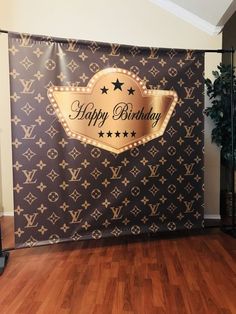 a happy birthday banner with stars on it in front of a wood floored room