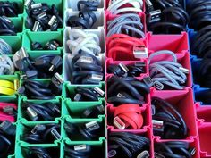 many different types of cables and cords in bins