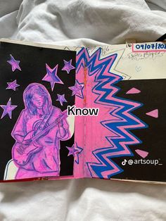 an open book with pink and blue stars on it, next to a drawing of a girl holding a guitar