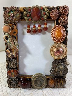 an ornate photo frame with many different items on the front and sides, all in various shapes and sizes