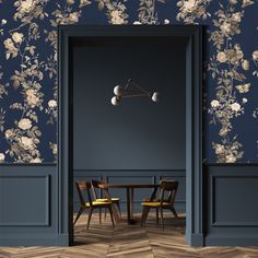 an open door leading to a dining room with blue walls and floral wallpaper on the walls