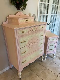 two pink dressers sitting next to each other in a room with tile flooring