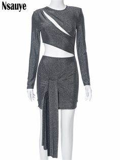 a mannequin wearing a silver dress with long sleeves and an asymmetric skirt