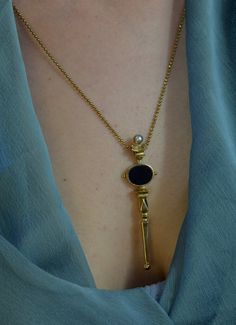 A sculptural  necklace, inspired of the scepters  of antiquity. This is a dreamy necklace crowned by a Black Onyx & a Freshwater Pearl. Carved in wax by hand, casted in Bronzeand polished to a beautiful burnished gold finish. Bronze is getting an elegant antique look by the passing of the time.  It is harmonized with a high quality long  ball chain and a handmade hook clasp. Circumference is 54 cm. The same design also comes in Sterling Silver 925. Looks great layered on it's own but do not hesi Dreamy Necklace, Wax Jewelry, October Jewelry, Sculptural Necklace, Faberge Jewelry, Alchemy Gothic, Talisman Necklace, Bronze Necklace, Onyx Necklace