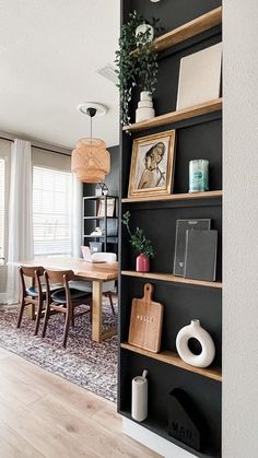 an open bookcase in the corner of a dining room