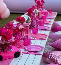 a long table with pink and purple decorations