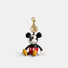 a mickey mouse keychain with a red and black outfit on it's face